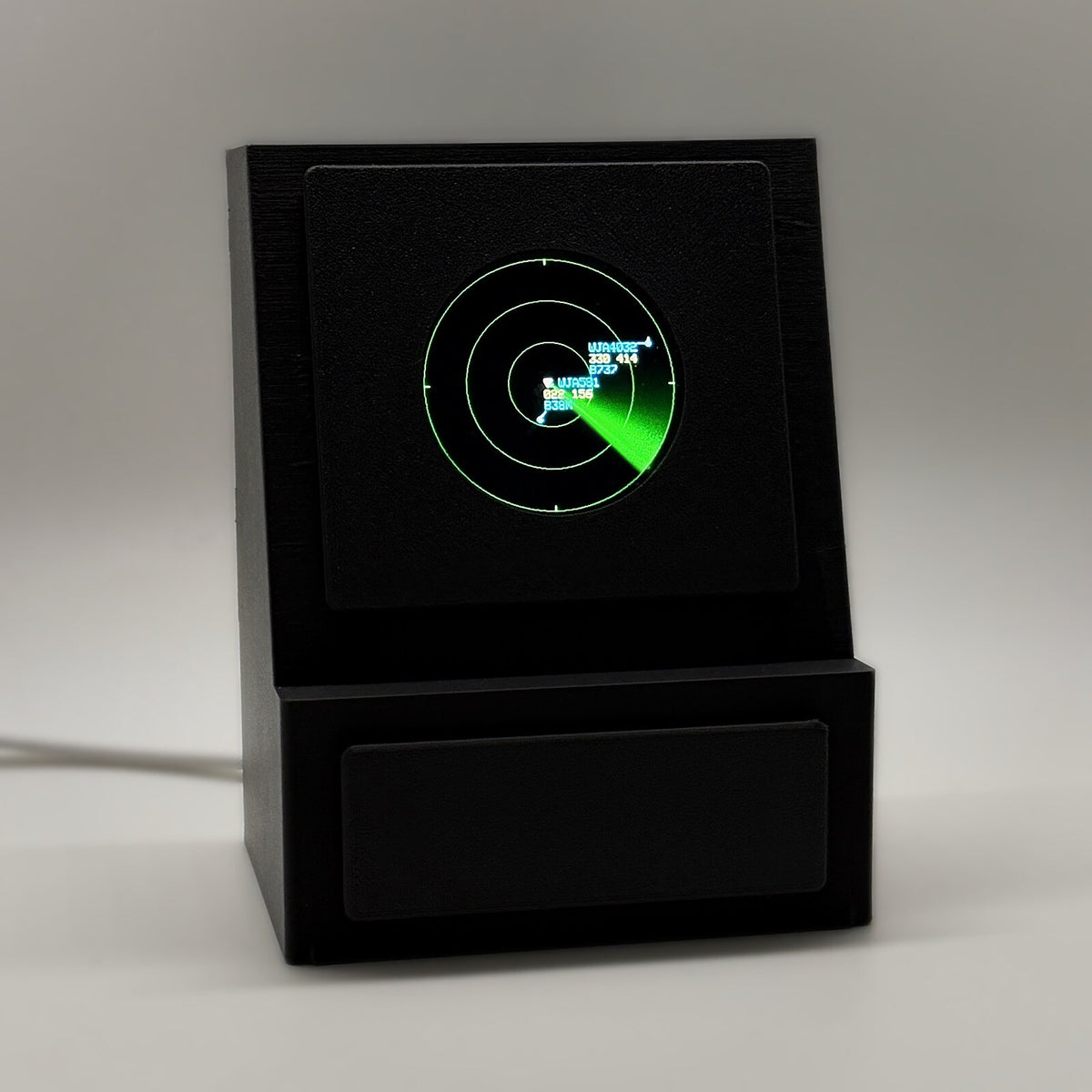 DeskSpotter aviation desk display showing a live radar map with a green sweep and aircraft tags